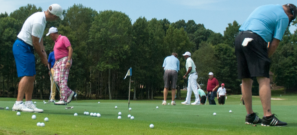 Pros and amateurs practiced putting during last year's tournament at River Run. (David Boraks/DavidsonNews.net)