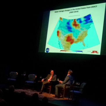NPR's Ira Flatow (left) and NASA water scientist Jay Famiglietti talked during Tuesday's discussion of "Our Water: An Uncertain Future." Famiglietti said red and yellow areas on the map are areas where water overuse is most critical. (David Boraks/WFAE)