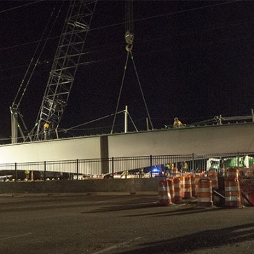 Workers prepared to move a girder Thursday night, Feb. 12, 2016, on the Blue Line extension at Harris Boulevard and North Tryon Street. (David Boraks photo)