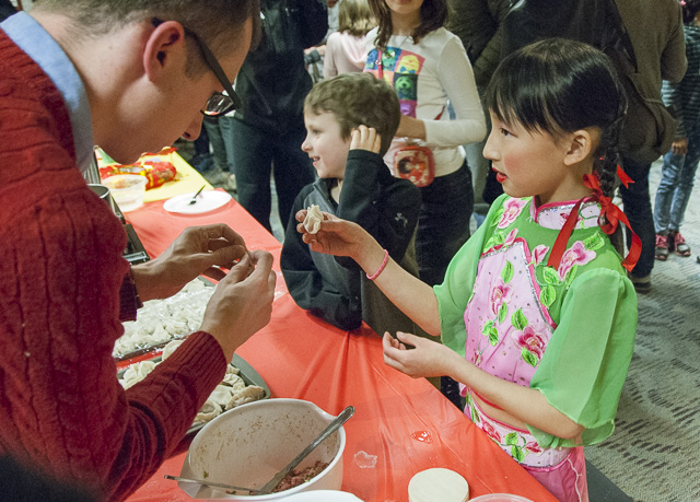 Guests at last year's celebration wrapped dumplings. (David Boraks photo)