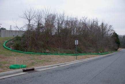 The slope had been covered with trees and other vegetation. This photo was taken in early January. (David Boraks/WFAE)