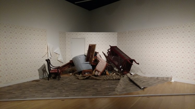 "Slow Room" by Jonathan Schipper is slowing being pulled together by a winch behind the wall.