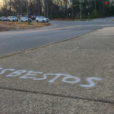 asbestos marking on pavement near intersection